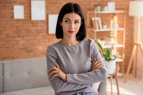 Thoughtful young woman at home