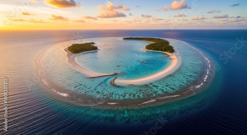 Fototapeta Naklejka Na Ścianę i Meble -  Aerial view of a stunning tropical island in the Maldives at sunset.