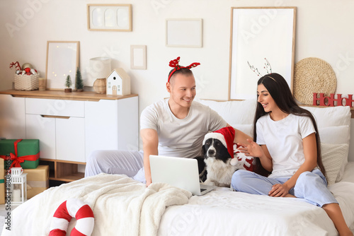 Young couple with dog using...