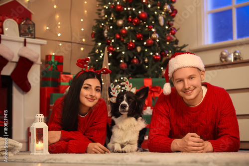 Happy young couple with dog...