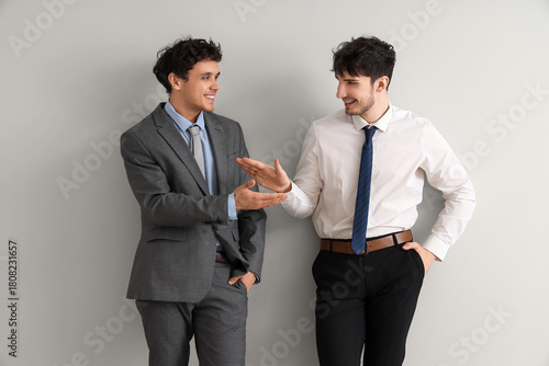 Young brothers in suits giv...