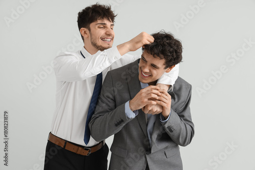 Young brothers in suits hug...