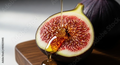 Honey dripping on a fresh fig half showcasing its vibrant red interior and sweet texture.