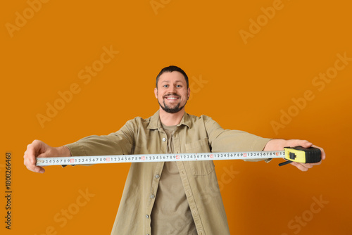 Young man with tape measure...
