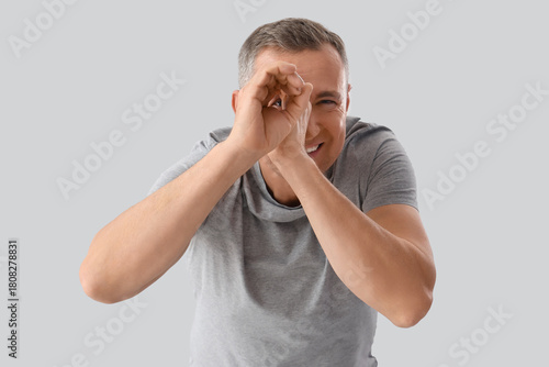 Mature man looking through ...