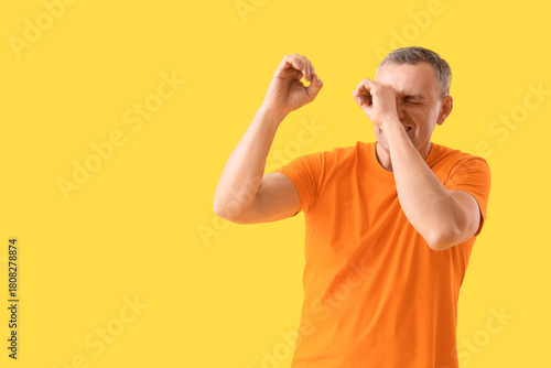 Mature man looking through ...