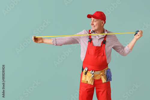 Male worker with tape measu...