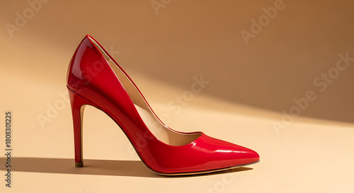 Single red high heel shoe isolated on beige background