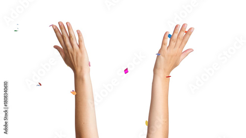 Raised hands throwing colorful party confetti celebrating success isolated on white background