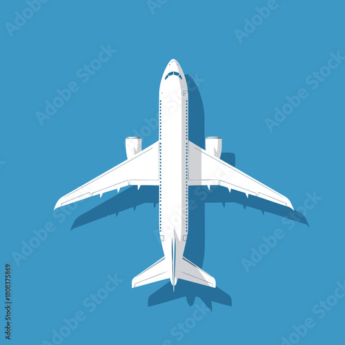 Top view of a white passenger airplane flying against a solid blue sky background with shadow