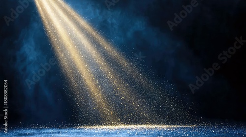 Golden light beams shine through blue smoke, illuminating a floor covered in sparkling particles, creating a dramatic and magical atmosphere.