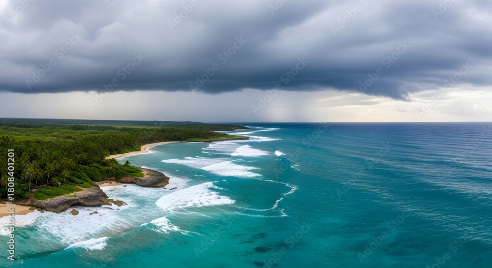 Fototapeta premium Turquoise ocean waves crash onto a lush green coastline under a dramatic stormy sky