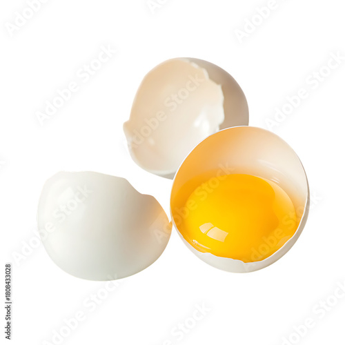 Cracked egg with bright yellow yolk and shell isolated on a transparent background
