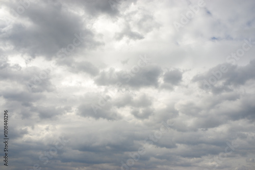 Expansive gray sky covered with dense stratocumulus clouds, creating dramatic and somewhat melancholic atmosphere. Overcast conditions suggest an approaching weather front, evoking feelings