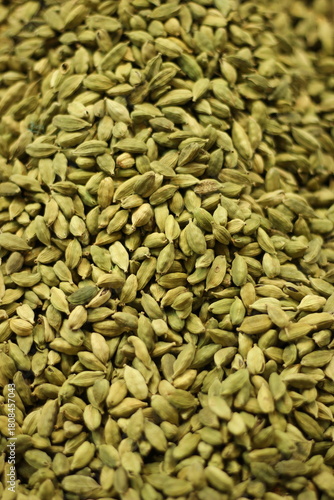 Green cardamom pods texture background showing whole elaichi spice seeds natural pattern closeup