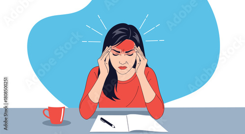 Woman holding her head and suffering from a severe headache at a desk with a coffee cup.