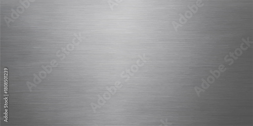 A brushed metal texture of stainless steel or aluminum plate with a shiny metallic surface and pattern for a gray industrial backdrop