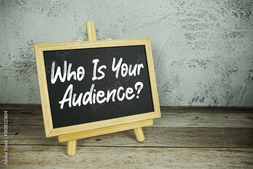 wooden easel displays a blackboard with the bold white text 