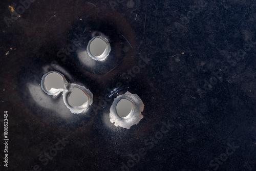 Real bullet holes on old metal , Can be used as a background