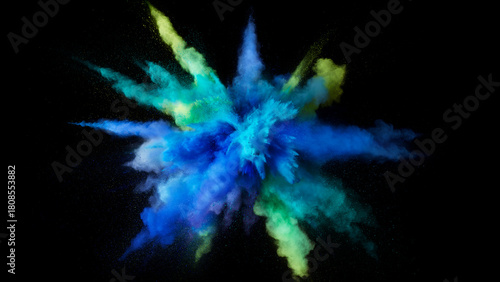 Blue and green powder explosion against a black background