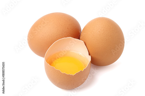 Fresh peeled chicken eggs reveal a bright yellow color and a full egg on the side. isolated on white background.