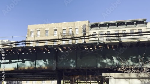 New York City elevated subway train passing overhead.
