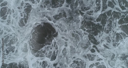 Surging sea waves hitting close-up.