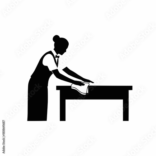 Silhouette of a waitress in uniform cleaning a dining table.