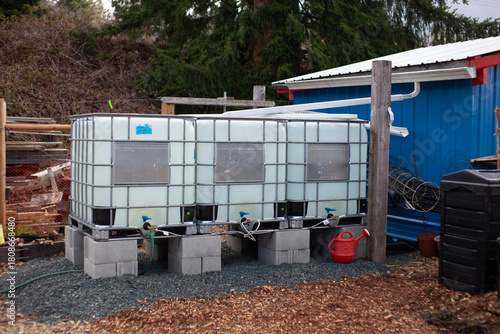 Three water storage tanks at a community garden for rain catchment