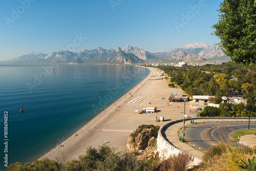 Fototapeta Naklejka Na Ścianę i Meble -  Aerial view of Konyaalti beach and pine-covered coastline at sunrise in Antalya