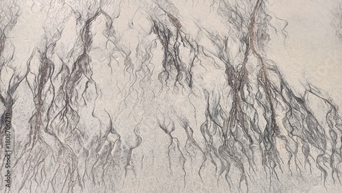 Abstract cracks and lines on sand top view, cracked sandy texture, creative art background, grunge pattern, aged surface, dry arid ground, erosion landscape, rough relief, marble effect, tree branches