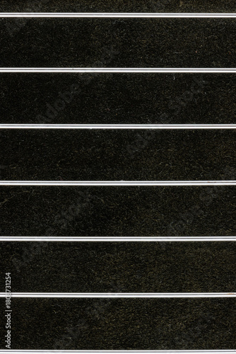 Shiny metal parallel lines on dark background