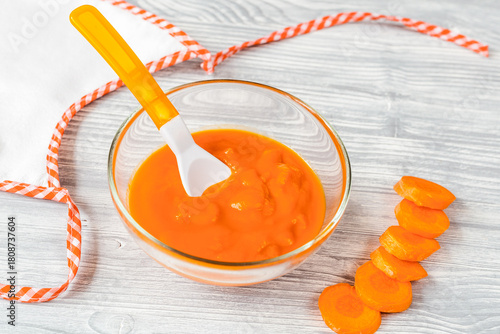 baby food - carrot puree on wooden background