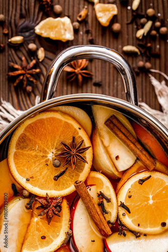 preparation of mulled wine in pot wooden background top view