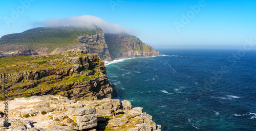 View of Cape Point from the Cape of Good Hope with the upper lighthouse (built in 1859) shrouded in mist, which is why in 1919,  the lower one was built. Cape Town. Western Cape. South Africa.