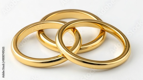 Three interlocking golden rings on a light surface, symbolizing unity and commitment.