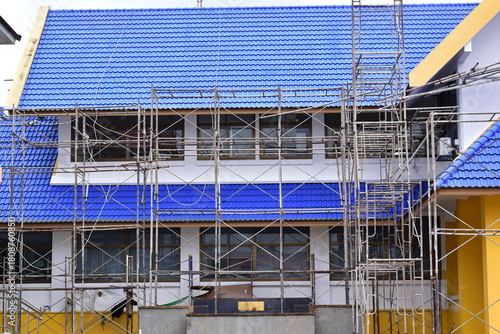 Scaffolding for building improvements, Renovation scaffolding enveloping historical building facade