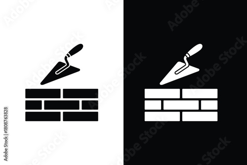 Bricklaying icon with trowel and wall in black and white