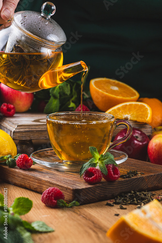 Tea is poured into a mug from a teapot