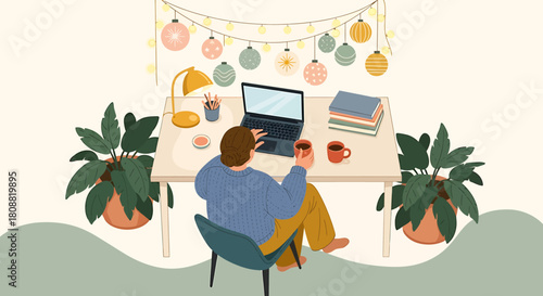 Person working at a desk with laptop and plants during the holidays.