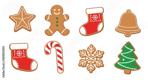 Festive collection of decorated gingerbread cookies in various holiday shapes, including a star, snowman, stockings, and a Christmas tree.
