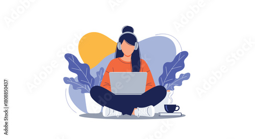 A young woman sits cross-legged, focused on her laptop while wearing headphones and enjoying a warm beverage, representing modern remote work and digital lifestyle.