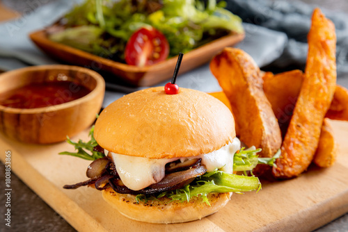 vegetarian mushroom burger, served with thick-cut potato wedges and a side salad toasted bun and features a thick layer of sautéed or caramelized red onions and mushrooms, melted white cheese