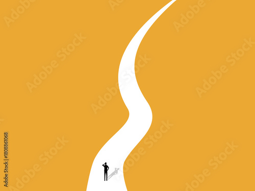 Businessman standing on a winding road