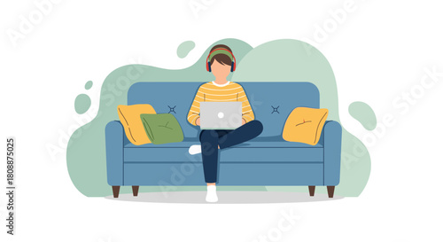 A person wearing headphones works on a laptop while sitting comfortably on a blue sofa, creating a relaxed atmosphere.