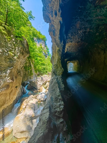 The gorge , a river and a road that goes inside the rock