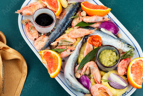 Plate with raw marinated seafood.