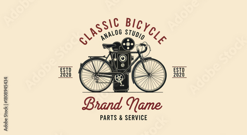 Vintage bicycle illustration with an old-fashioned film projector attached to the back, surrounded by decorative text and elements.