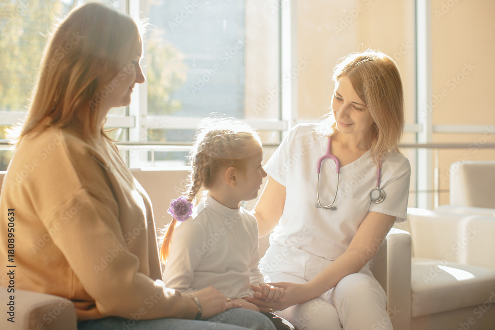Fototapeta premium Female doctor comforting child and mother in clinic