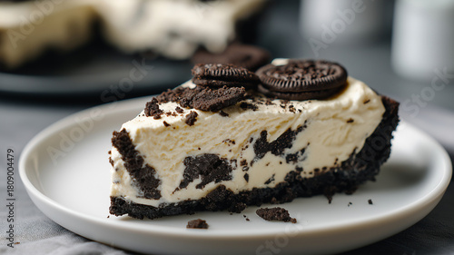 Wallpaper Mural Slice of creamy cheesecake with chocolate cookie crust is topped with crushed cookies on white plate, creating delicious and inviting dessert Torontodigital.ca